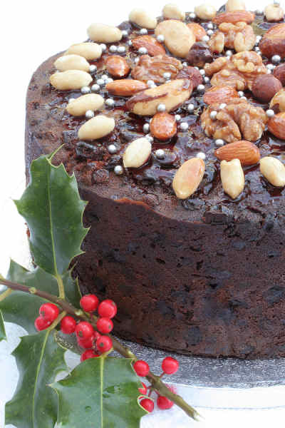 Christmas cake with glaze and nut decoration on top